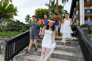 Stunning asian bride and groom walk down stairs to their 5 star wedding in Warwick Fiji