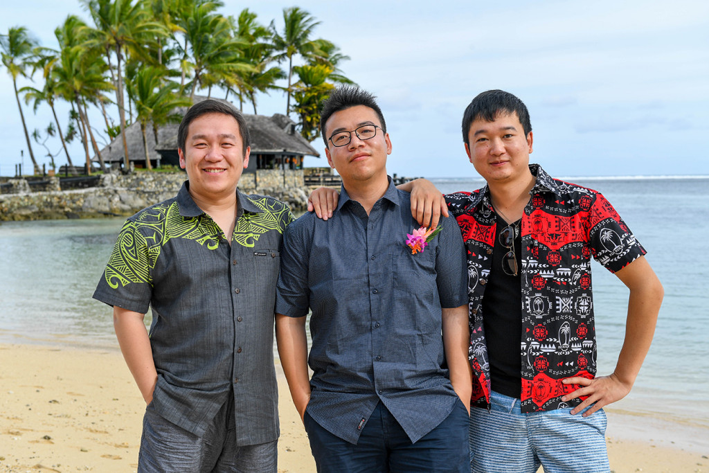 The asian groom poses with his friends on Warwick beach Fiji