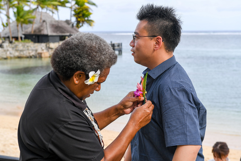 Asian groom gets Fiji plumeria flower in Warwick Fiji wedding