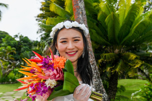 Stunning asian bride holds up flower bouquet in Warwick Fiji wedding