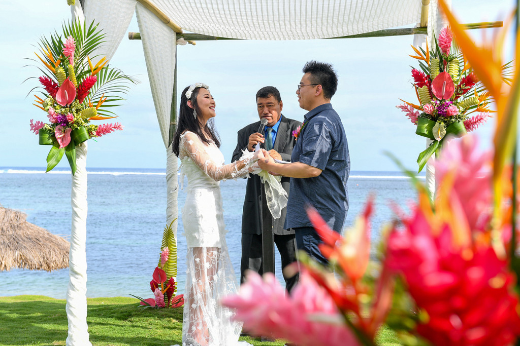 Married couple exchanging vows under gazebo in Warwick Fiji wedding