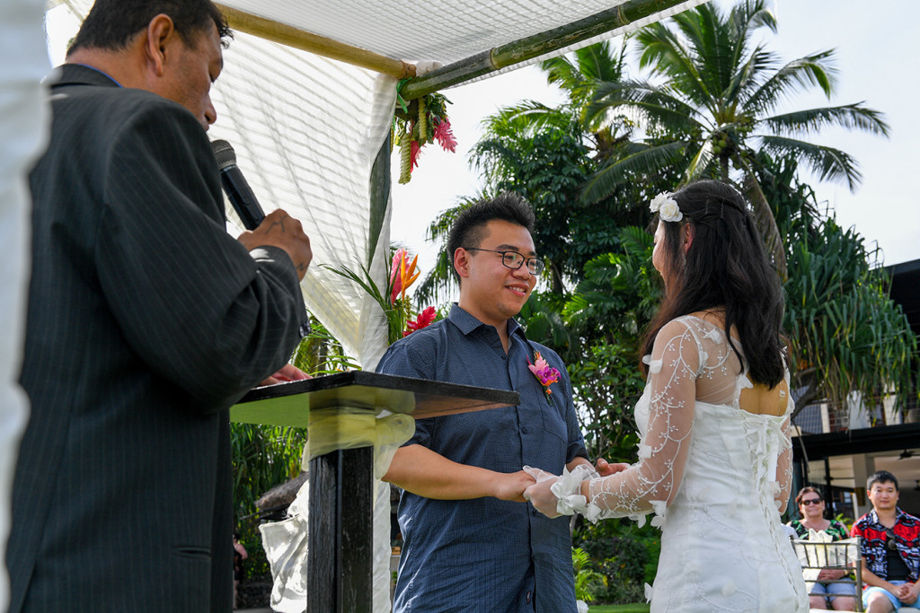 Asian couple hold hands under gazebo in Warwick 5star beach wedding