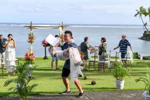 Groom carries his bride against the ocean in Warwick Fiji