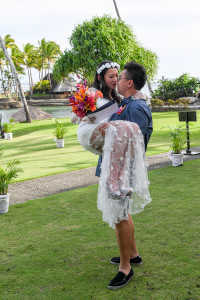 Groom carries and kisses his bride in Warwick Fiji
