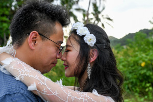 Married asian couple touch noses in Warwick Fiji wedding photoshoot