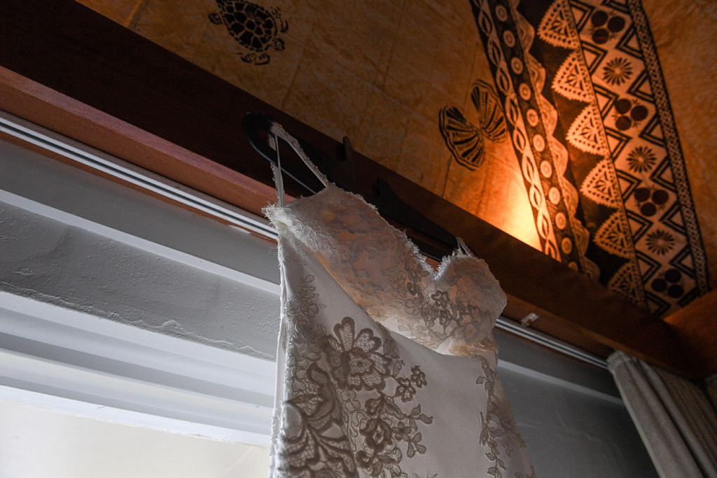 Closeup of bohemian wedding dress against traditional Fiji print