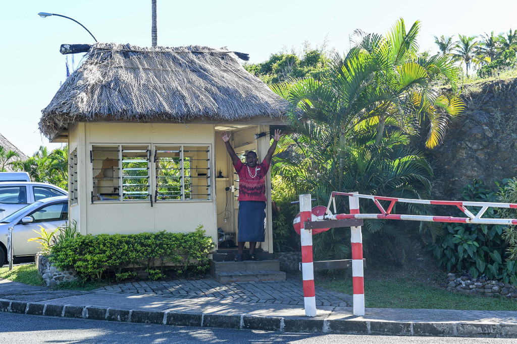 Fiji greets camera at Outrigger Entrance in Fiji wedding