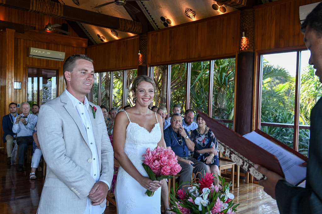 Bride and groom smile at the celebrant in Fiji Outrigger wedding
