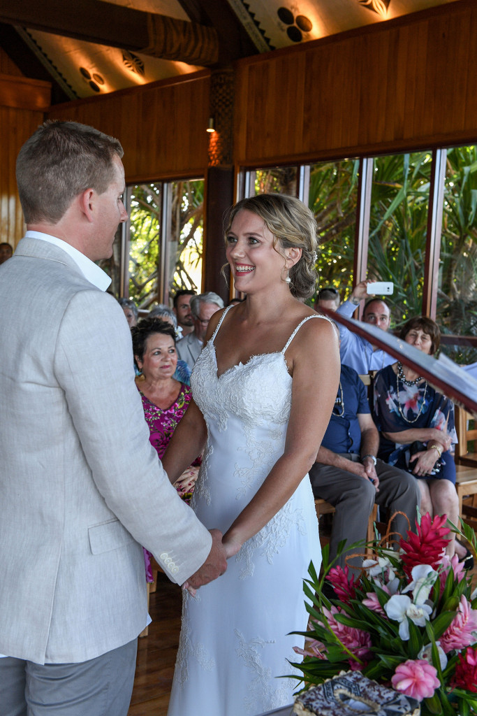 Bride and groom hold hands at the altar in Outrigger wedding