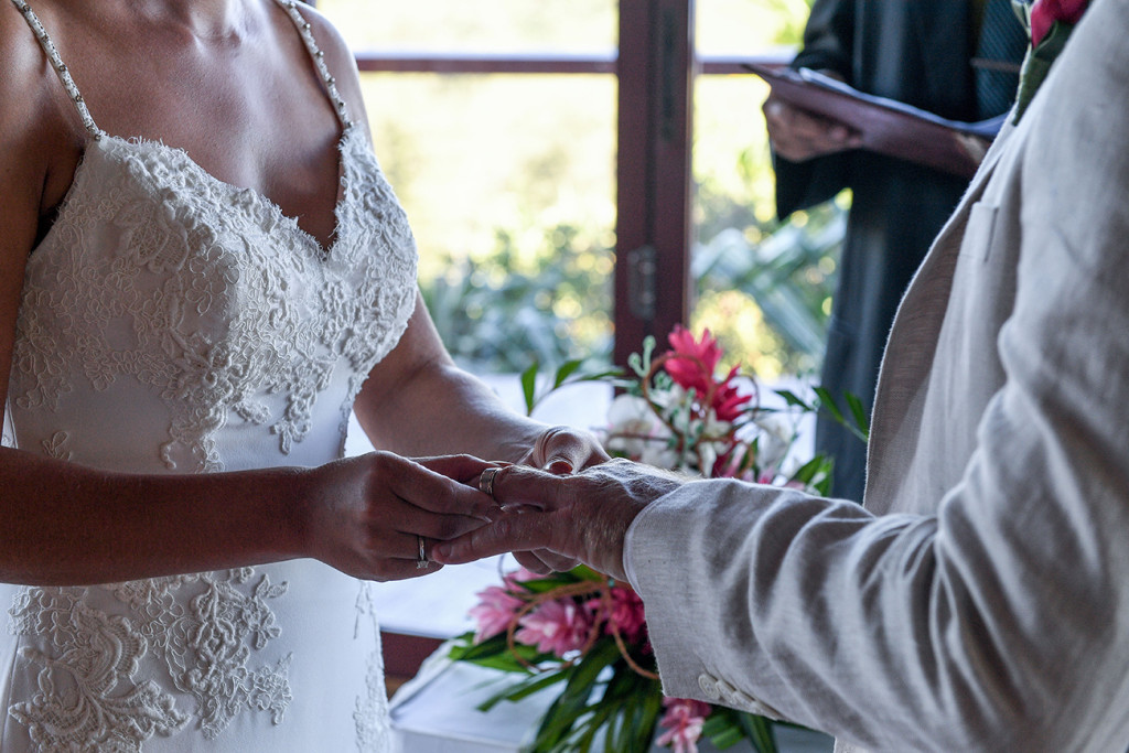 Bride puts ring on the groom