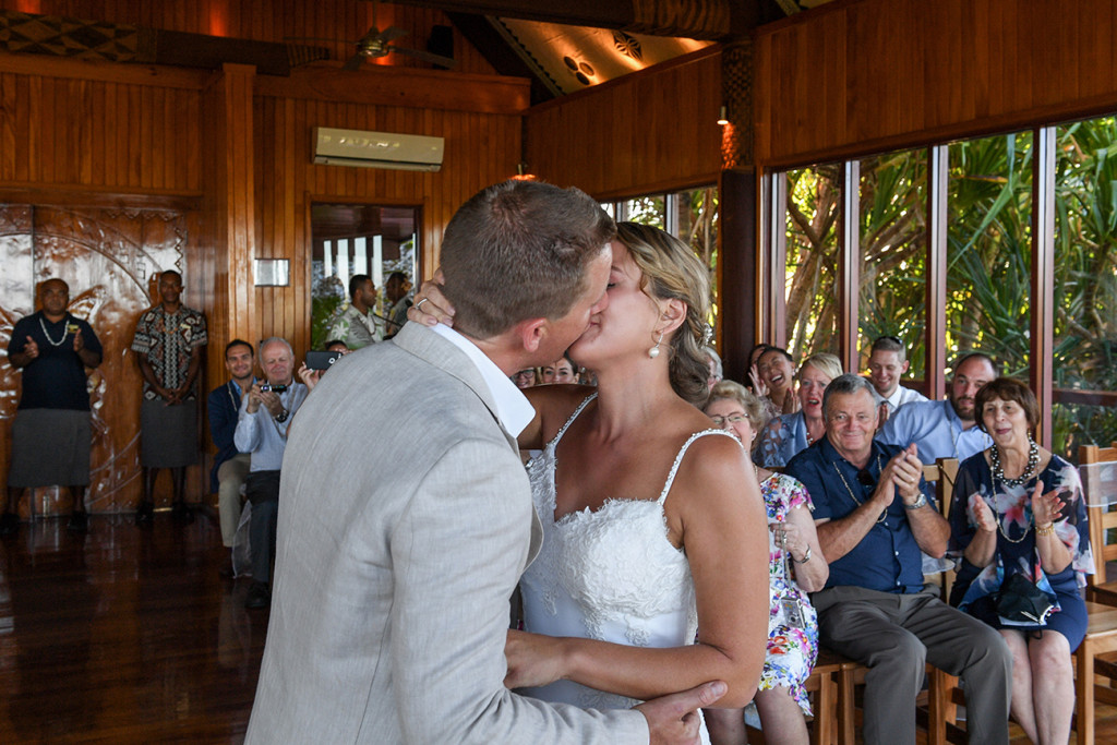 Groom and Bride kiss at the altar in The Outrigger Fiji