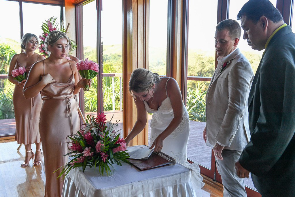 Bride signs marriage certificate in Fiji wedding