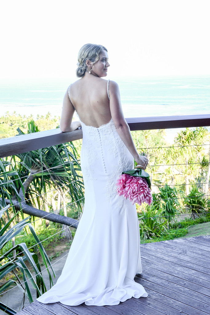 Back view of bride looking at the sea at the Outrigger Fiji