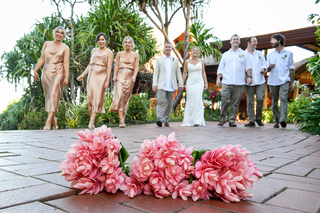 Flowers in the foreground and bridal party in the background