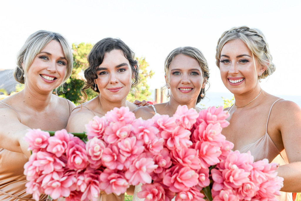 Pink tropical flower bouquets and bridesmaids in The Outrigger Fiji