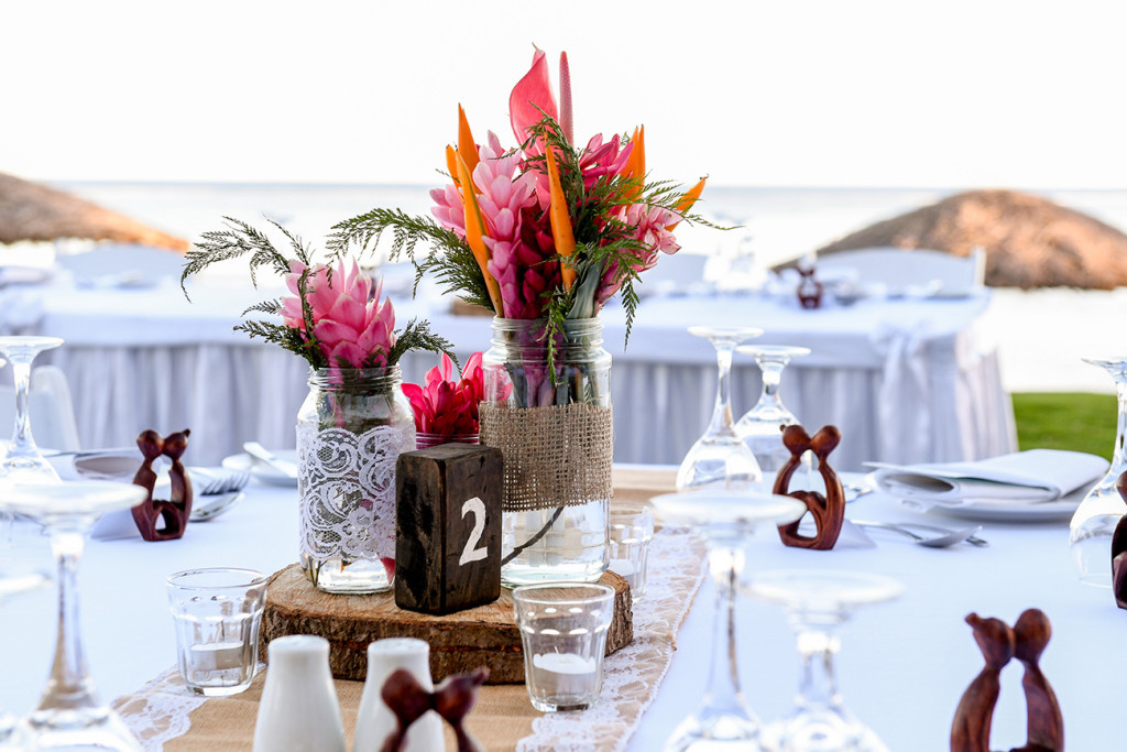 Intricate table setup at the reception at the Outrigger Restaurant against the sea