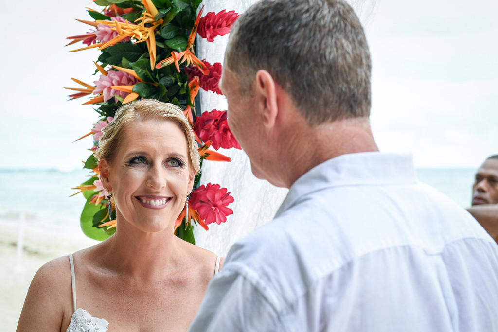 Bride smiles at groom at the altar Fiji Tropical wedding