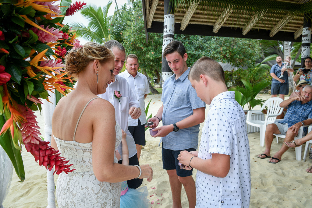 Best boys hands over rings to married couple at Plantation Island Resort Tropical wedding