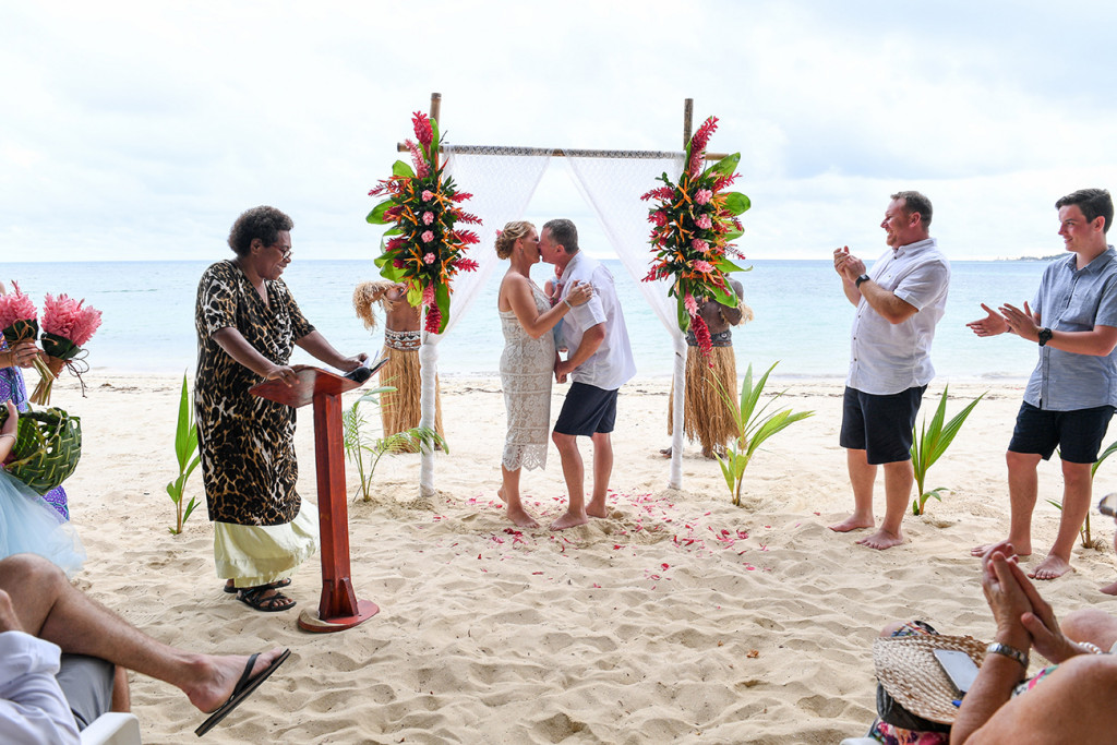 Bride and groom kiss on the beach against the sea in Tropical beach wedding Fiji
