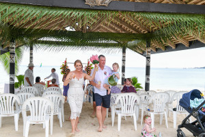 Happily married couple walk down aisle of beach Plantations Island Resort Wedding