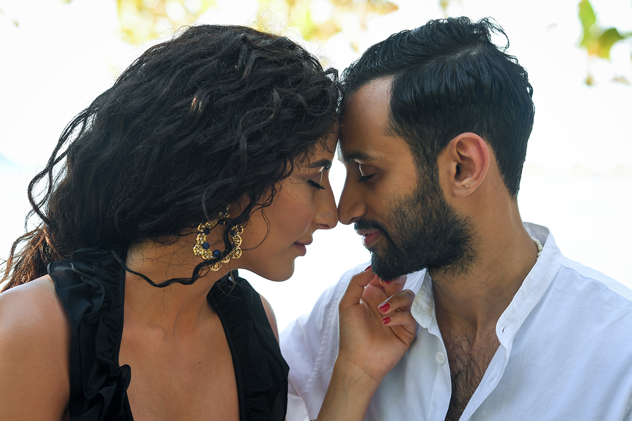Loving arab couple touch noses during their honeymoon photoshoot