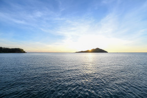 Stunning sunset behind island captured by Anais Chaine Fiji honeymoon photographer
