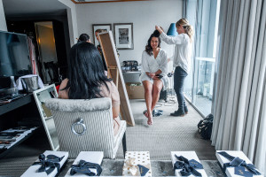 Bride's hair being straightened during prep in the Sofitel Auckland