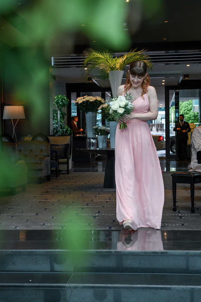 Bridesmaid walks down the aisle at the Sofitel Auckland