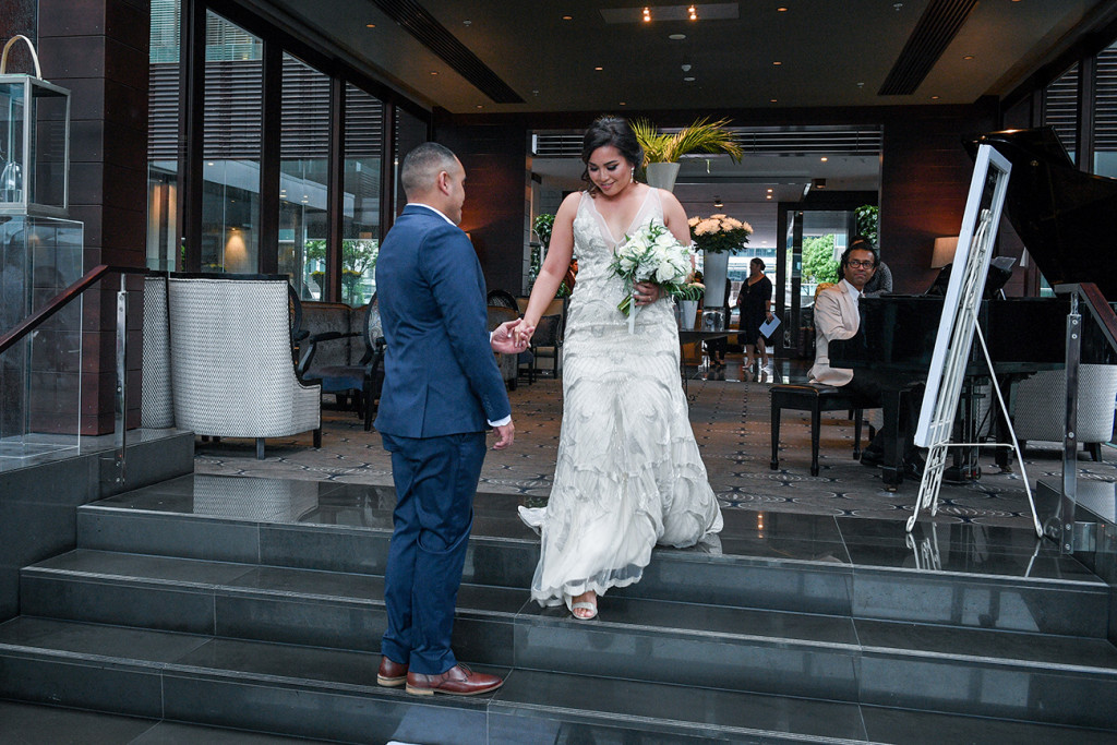 Groom receives his bride at the altar in the Sofitel Auckland