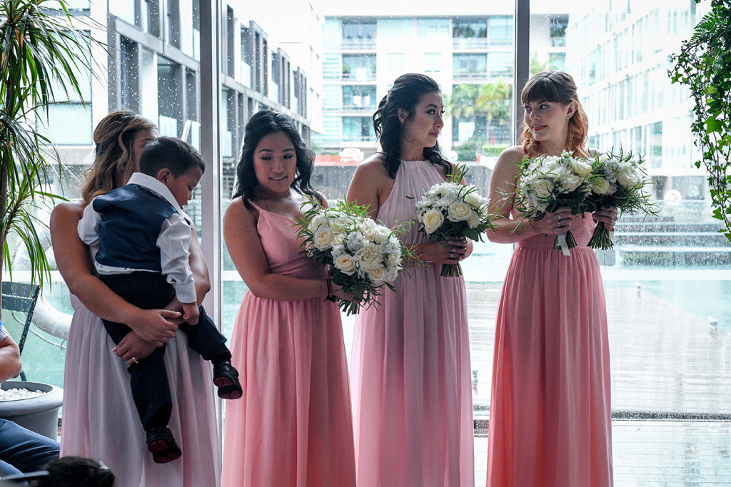Bridesmaids in pink standing at the altar
