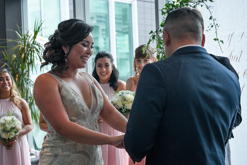 Groom puts the wedding on the bride at the Sofitel Auckland