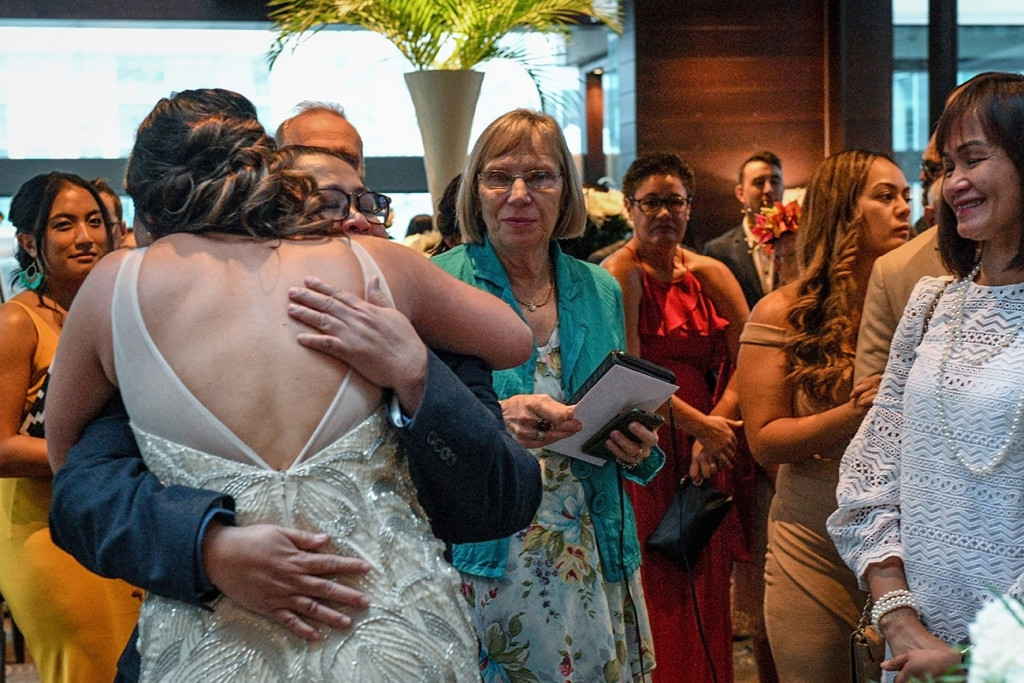 Bride hugs her father at the Sofitel Auckland wedding