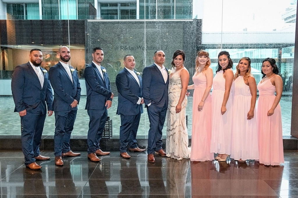 Bride groom and bridal party pose at the Viaduct Sofitel Auckland