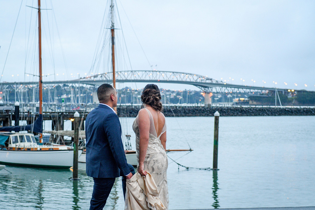 Bride and groom overlook the Auckland viaduct during their wedding shoot