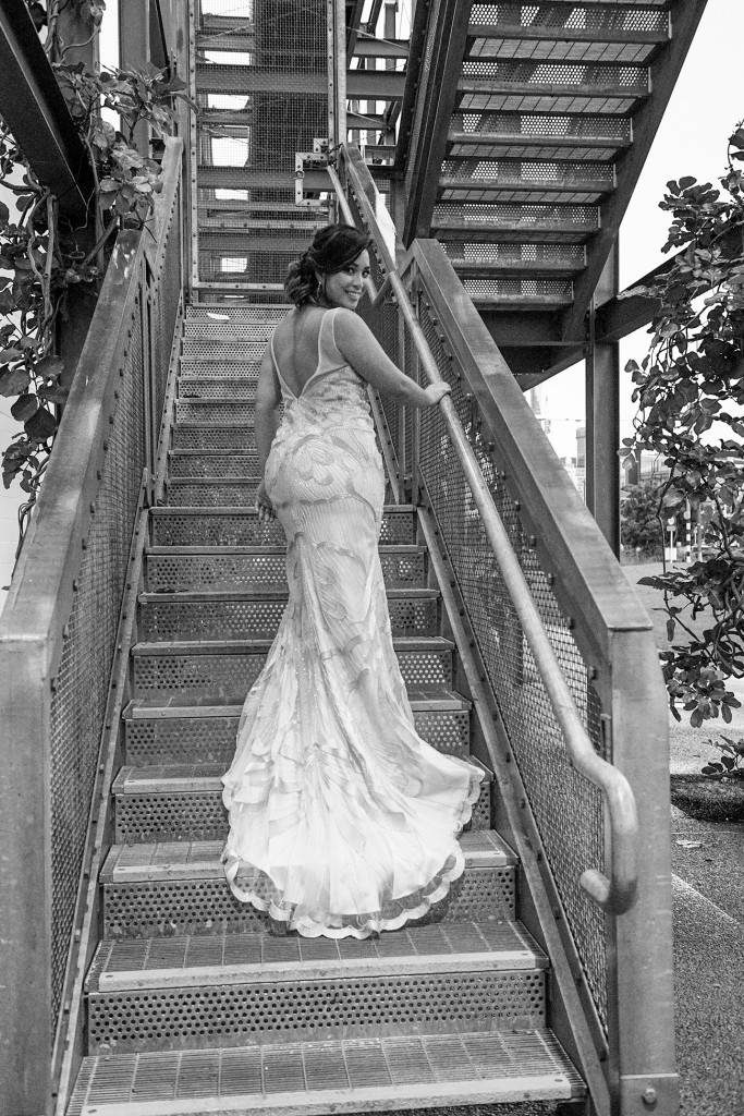 Monochrome photo of bride walking up steps