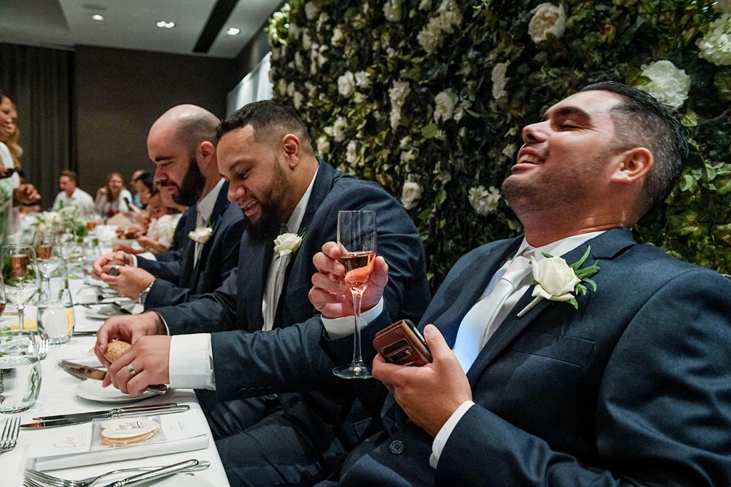 Groomsmen laugh at a toast