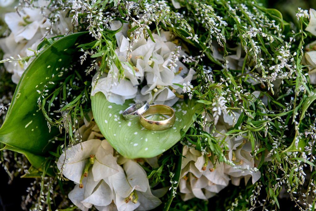 Gold wedding rings resting on a leaf at Sofitel Fiji wedding