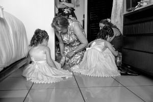 Black and white photo of flowergirls getting ready in wedding preparations