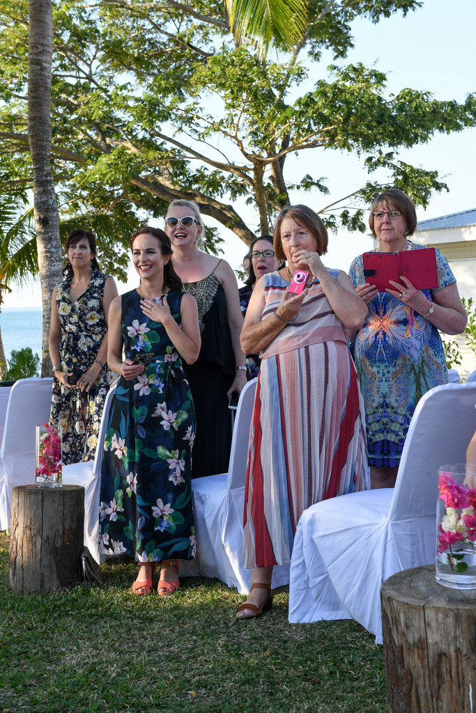 Wedding guests rise to welcome the couple to the cermony on Sofitel Fiji