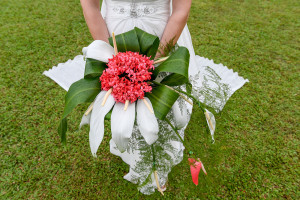 Closeup of bride's enormous crimson native Fiji flower bouqet