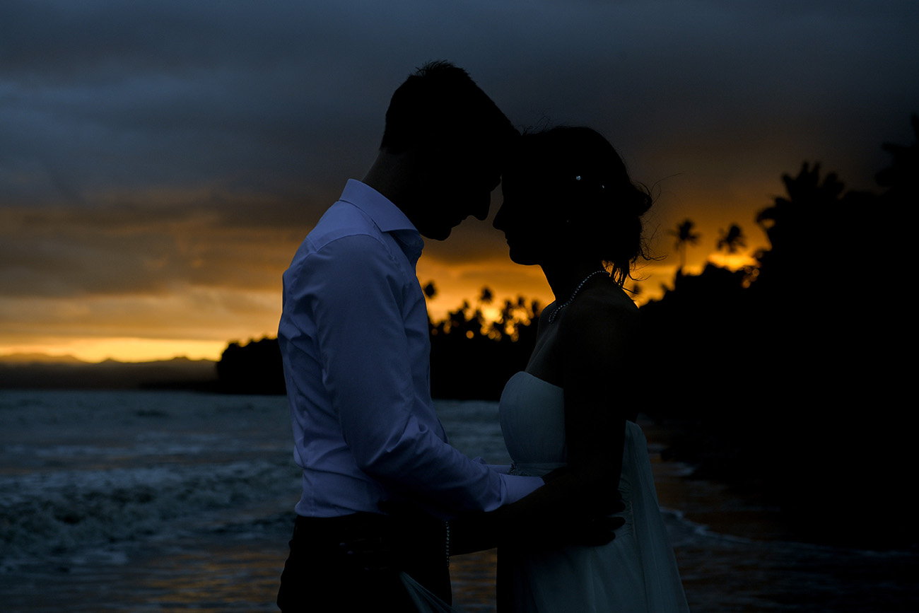 Bride and groom at the beach against the fiery Fiji sunset