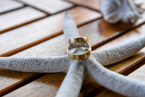 German couple's golden rings ontop of a starfish
