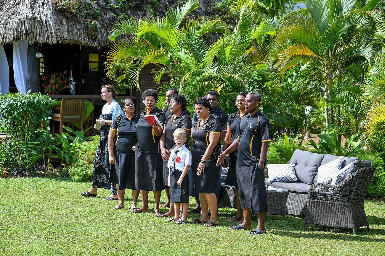 Fiji wedding guests rise awaiting the bride in Savusavu Island Fiji