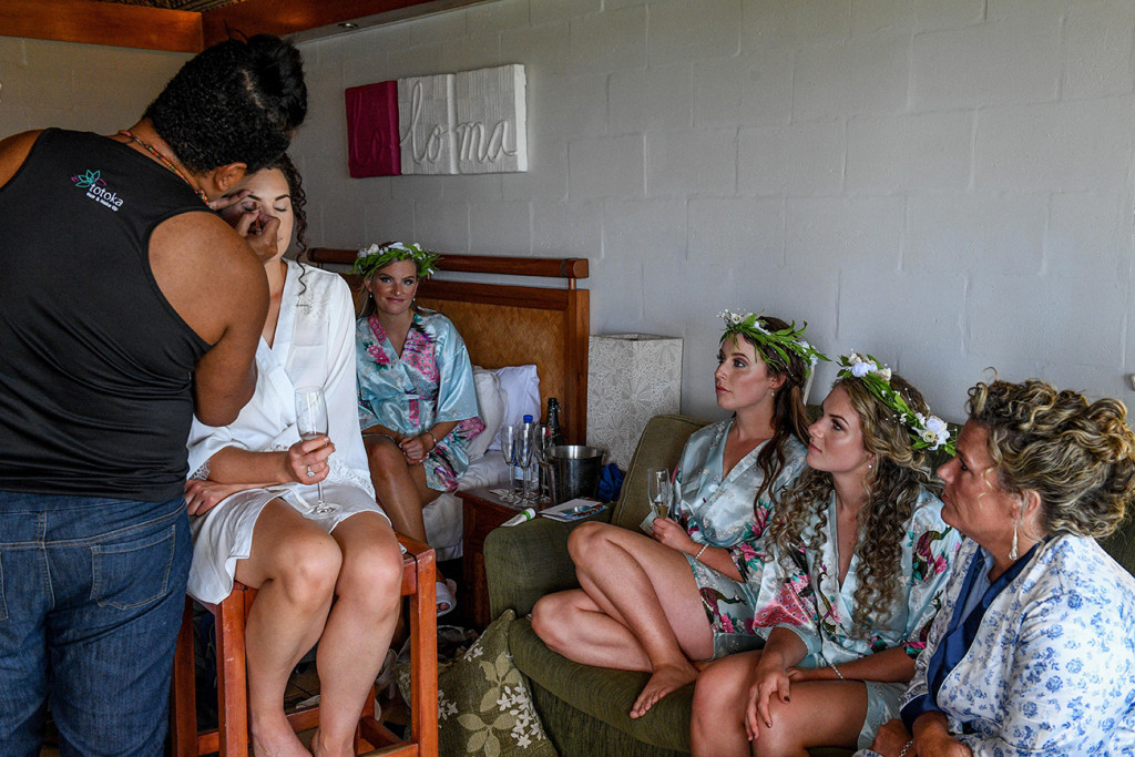 Bridesmaids watch as bride's makeup is done by Totoka Hair and Makeup