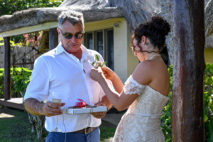 Bride adjusts boutonniere on her dad's shirt in Fiji wedding