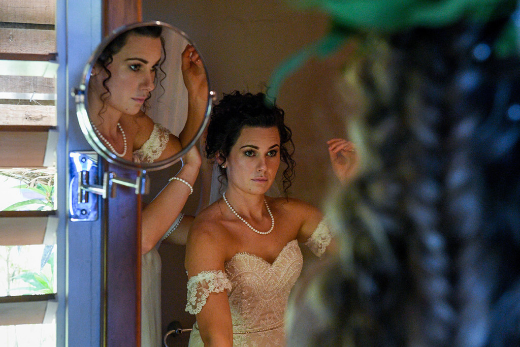 Reflection of bride in off-white off shoulder wedding dress