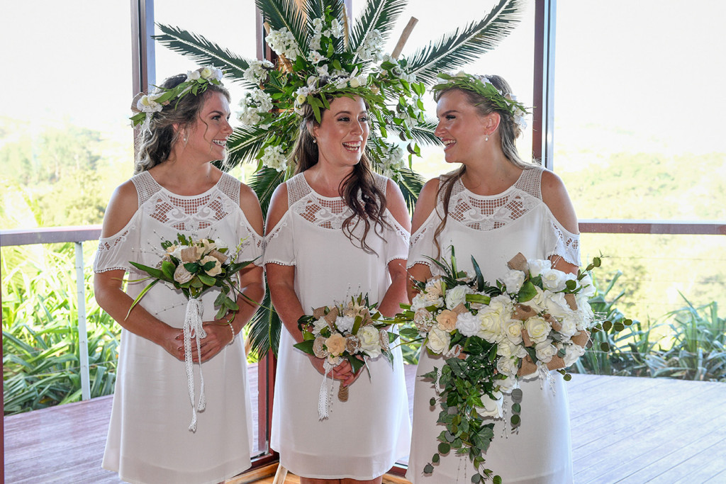 Bohemian bridesmaids in boho white off shoulder dresses and white flower bouquet at the Outrigger Fiji