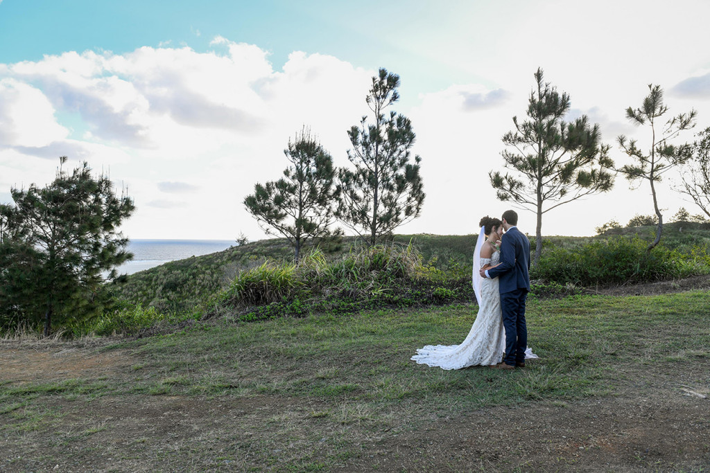 Wideshot of bride and groom kissing on Outrigger Fiji hills