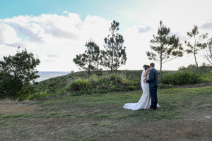 Wideshot of bride and groom kissing on Outrigger Fiji hills