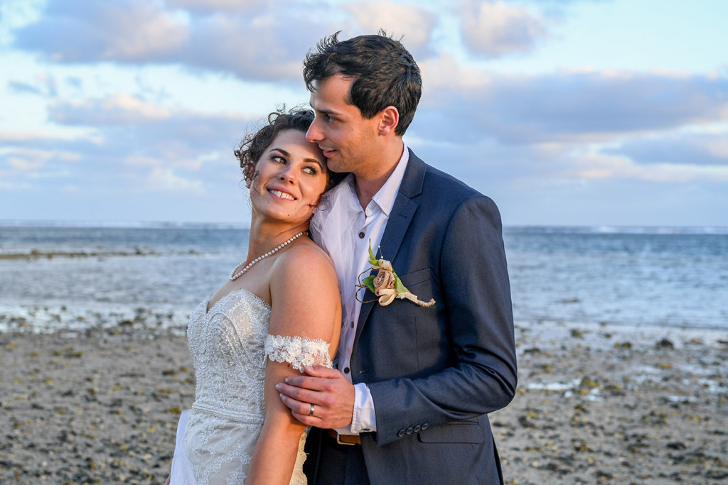 Golden sunrays glow off the bride and groom at the Outrigger Fiji
